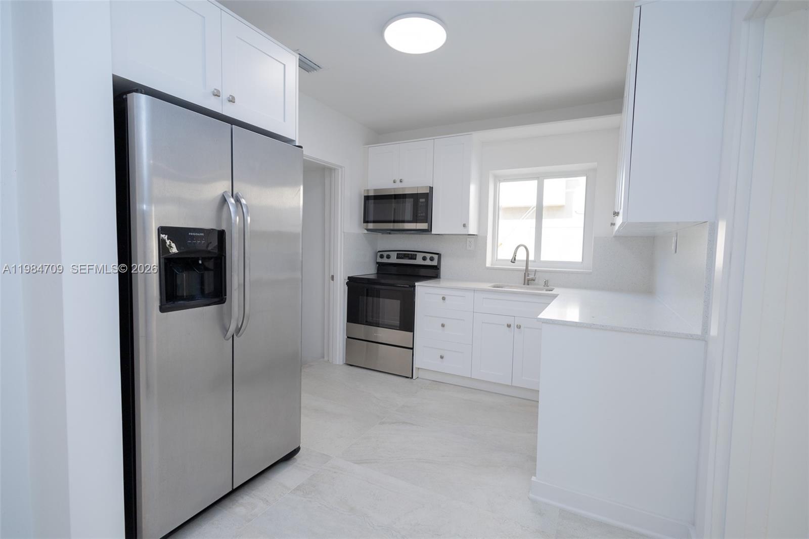 2675 Southwest 24th Terrace Miami, FL 33145 - Photo 8 of 36 a kitchen with cabinets and stainless steel appliances