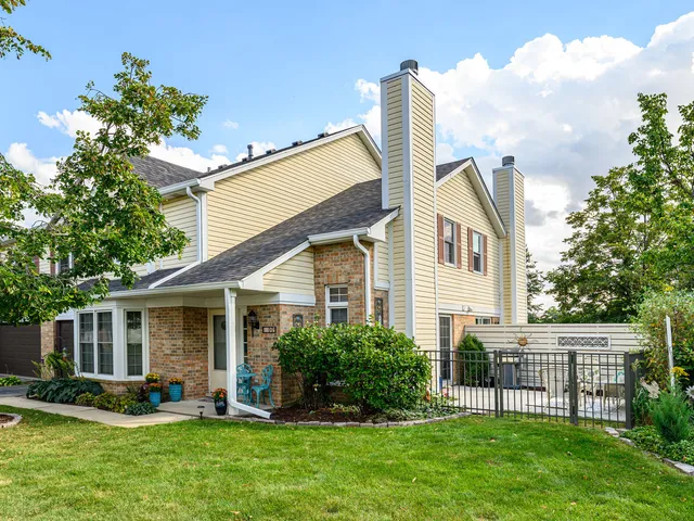 a front view of a house with a yard and porch