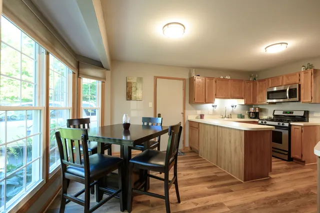 a view of a dining room with furniture windows and wooden floor