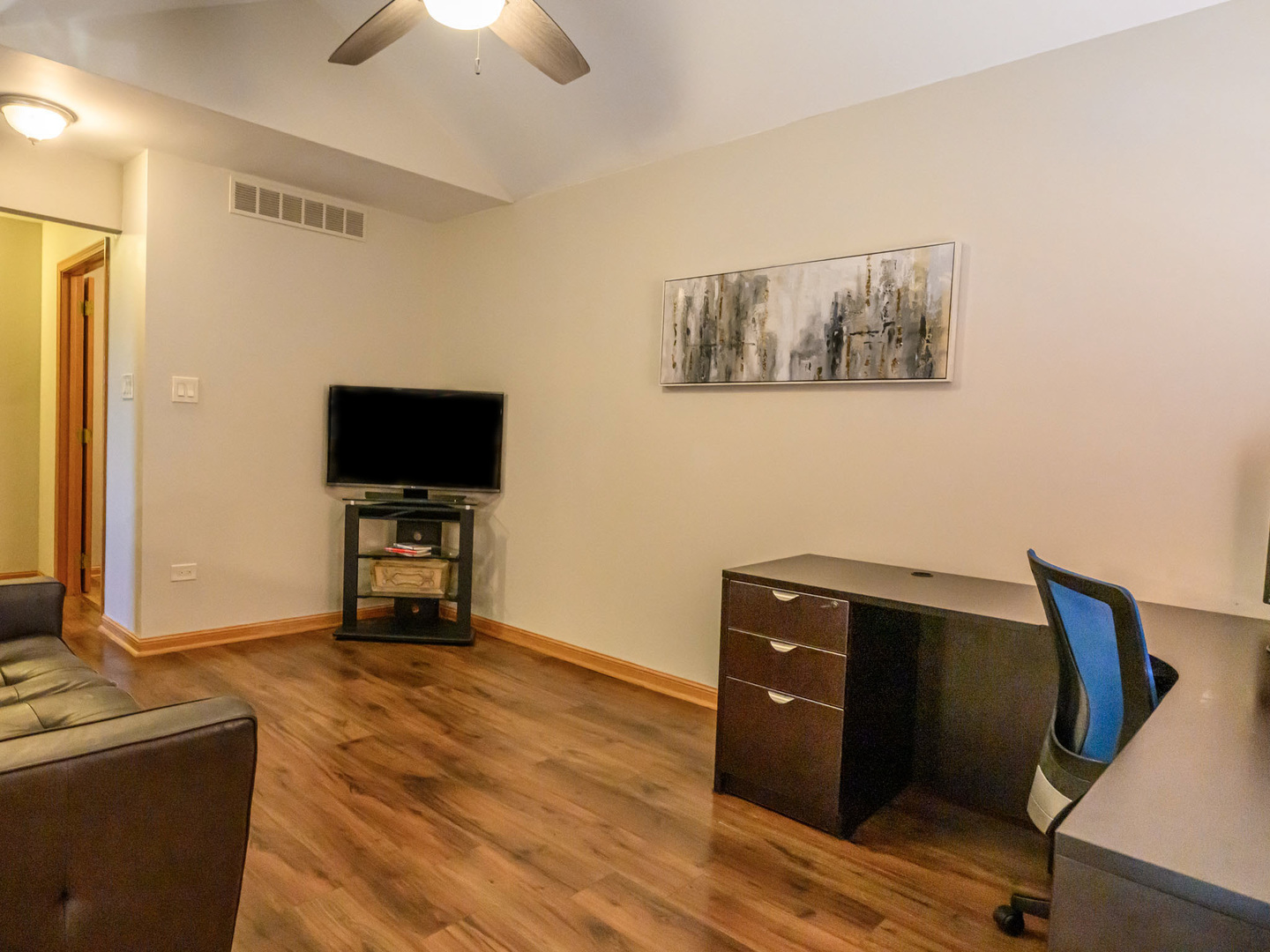 10111 Cambridge Drive, Unit COURTG Mokena, IL 60448 - Photo 17 of 31 a view of a workspace with furniture and a flat screen tv