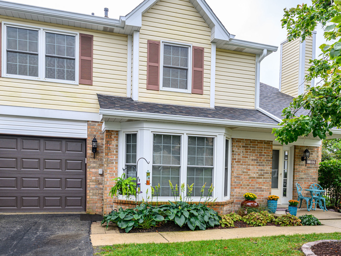 10111 Cambridge Drive, Unit COURTG Mokena, IL 60448 - Photo 2 of 31 a front view of a house with garden