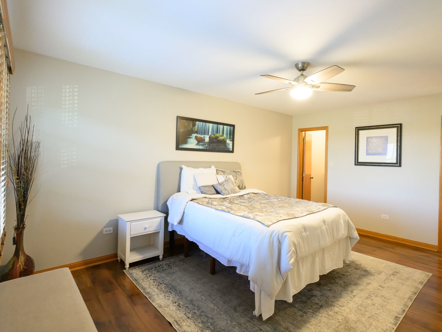 10111 Cambridge Drive, Unit COURTG Mokena, IL 60448 - Photo 22 of 31 a bedroom with a bed and a chandelier