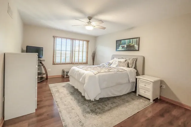 a spacious bedroom with a bed and a chandelier