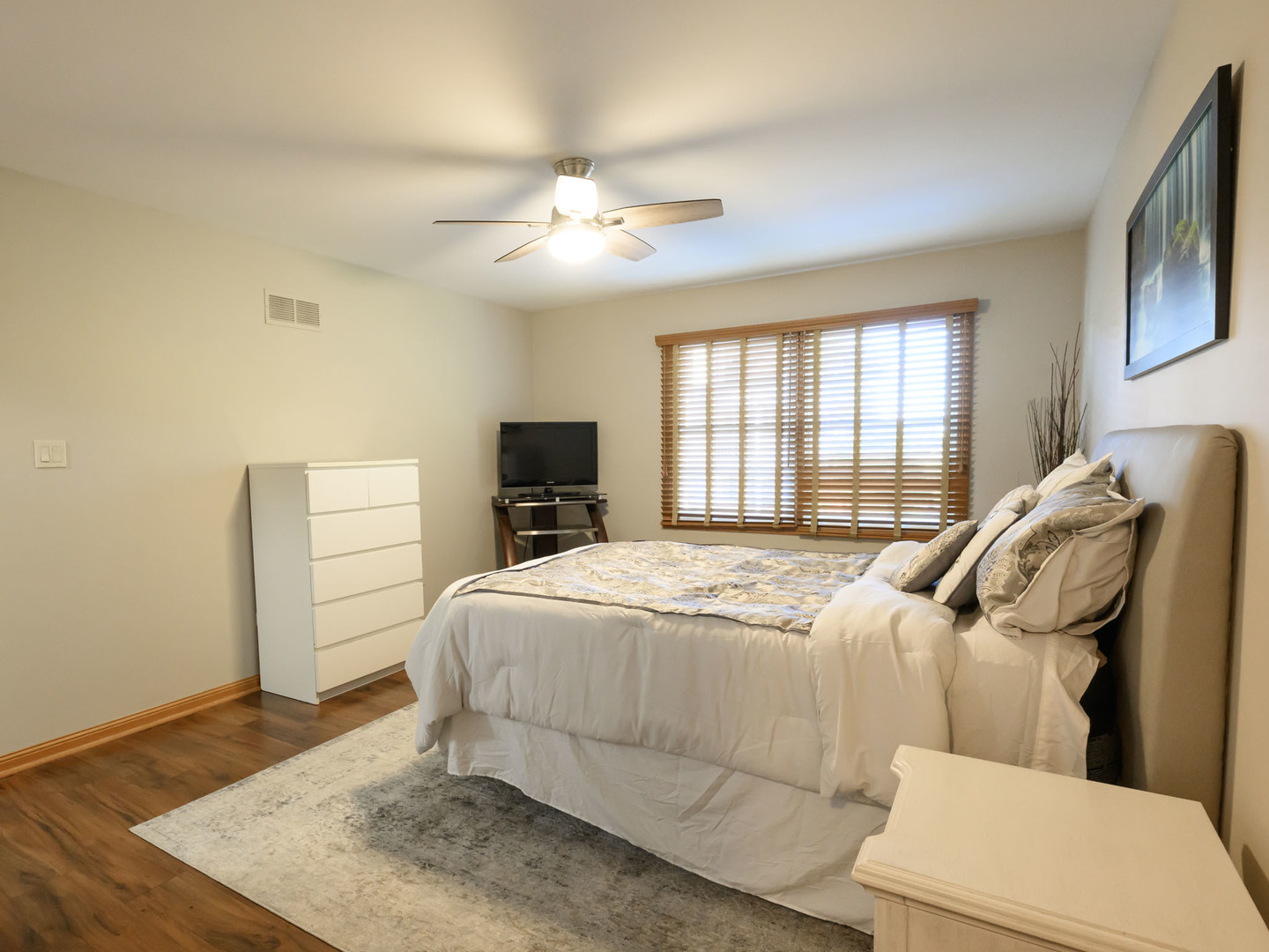 10111 Cambridge Drive, Unit COURTG Mokena, IL 60448 - Photo 24 of 31 a bedroom with a bed and wooden floor