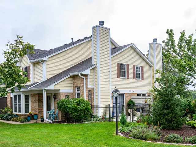 a view of a house with a yard and plants