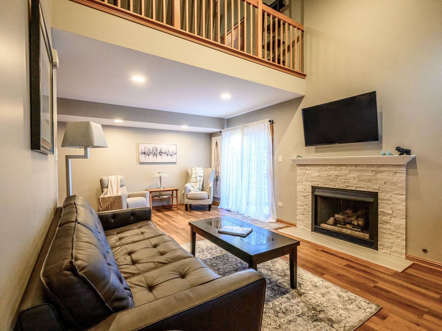 10111 Cambridge Drive, Unit COURTG Mokena, IL 60448 - Photo 4 of 31 a living room with furniture a flat screen tv and a fireplace