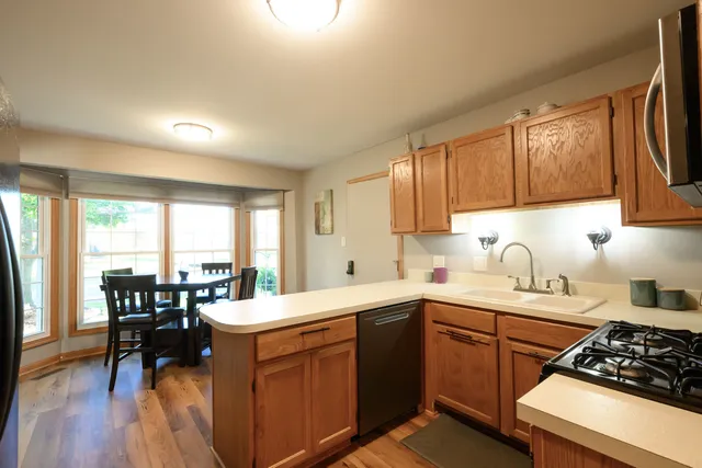 a kitchen with a sink stove and cabinets