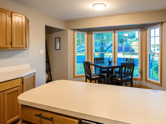 a dining room with a large window and furniture