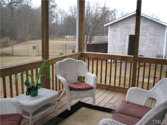 7260 Turner Fish Road Willow Spring, NC 27592 - Photo 11 of 14 a view of balcony with wooden floor and outdoor seating