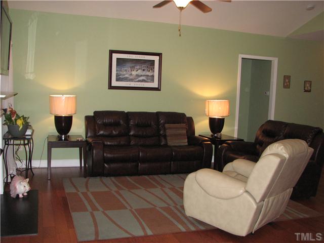 7260 Turner Fish Road Willow Spring, NC 27592 - Photo 14 of 14 a living room with furniture a lamp and a lamp