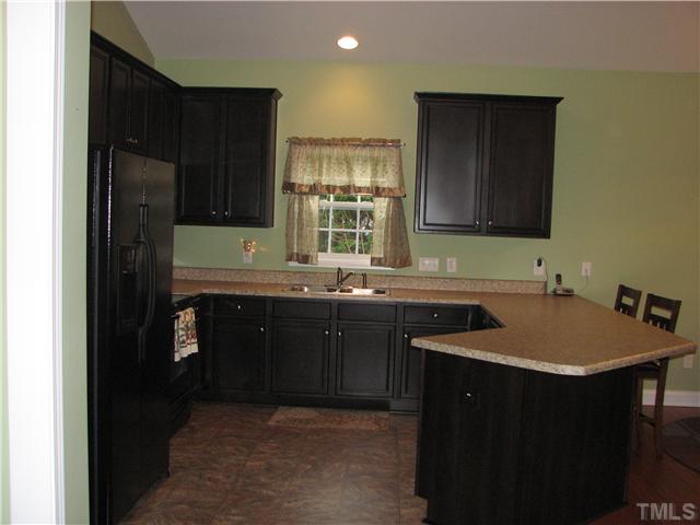 7260 Turner Fish Road Willow Spring, NC 27592 - Photo 4 of 14 a kitchen with stainless steel appliances granite countertop a sink stove and refrigerator