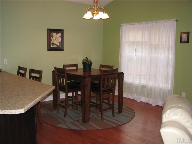7260 Turner Fish Road Willow Spring, NC 27592 - Photo 5 of 14 a view of a dining room with furniture window and wooden floor