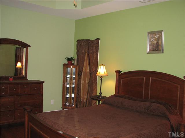 7260 Turner Fish Road Willow Spring, NC 27592 - Photo 7 of 14 a bedroom with a bed and dresser