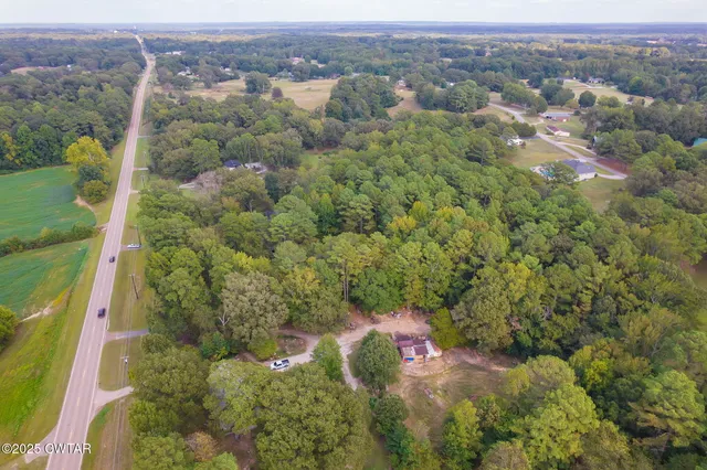 an aerial view of a houses with a yard