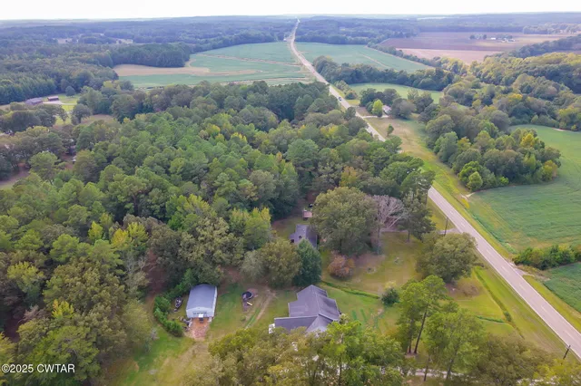 an aerial view of a house with a yard