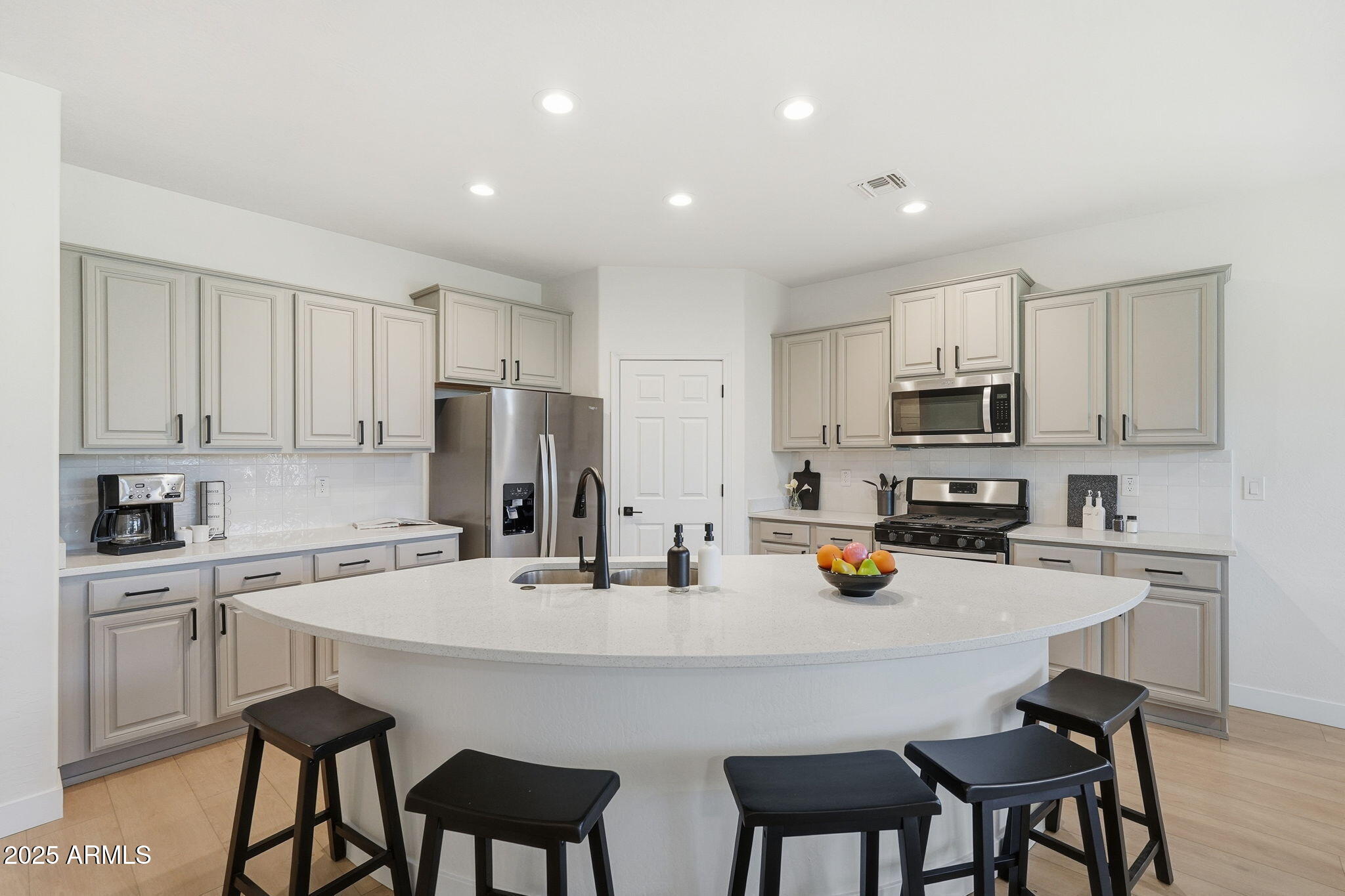 8159 West Cinder Brook Way Florence, AZ 85132 - Photo 14 of 32 a kitchen with appliances a table and chairs in it