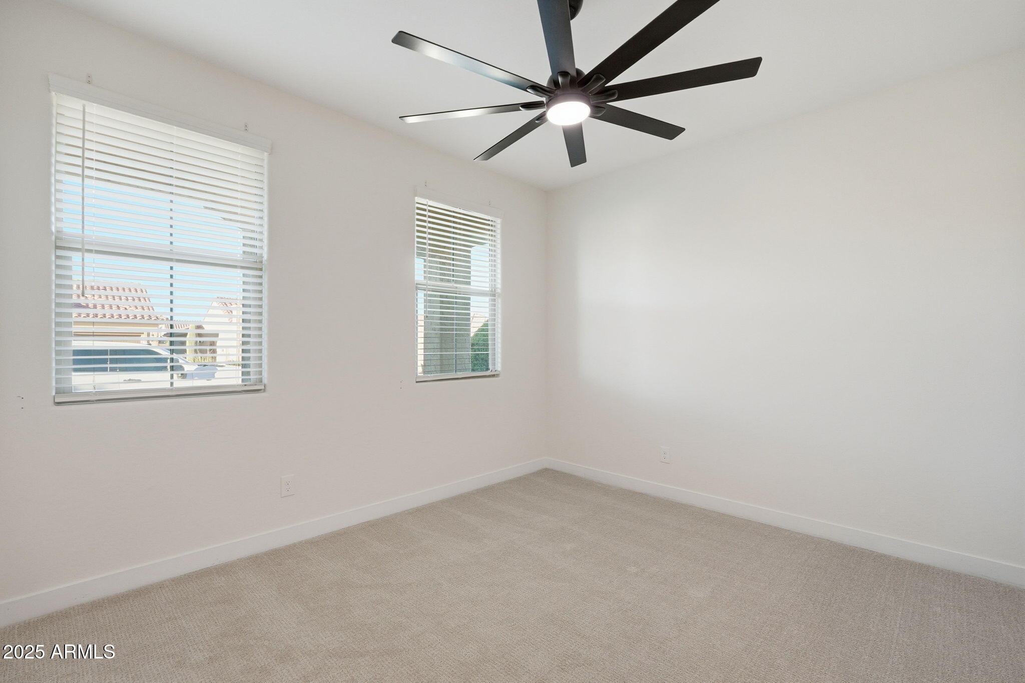 8159 West Cinder Brook Way Florence, AZ 85132 - Photo 19 of 32 an empty room with a window and a fan