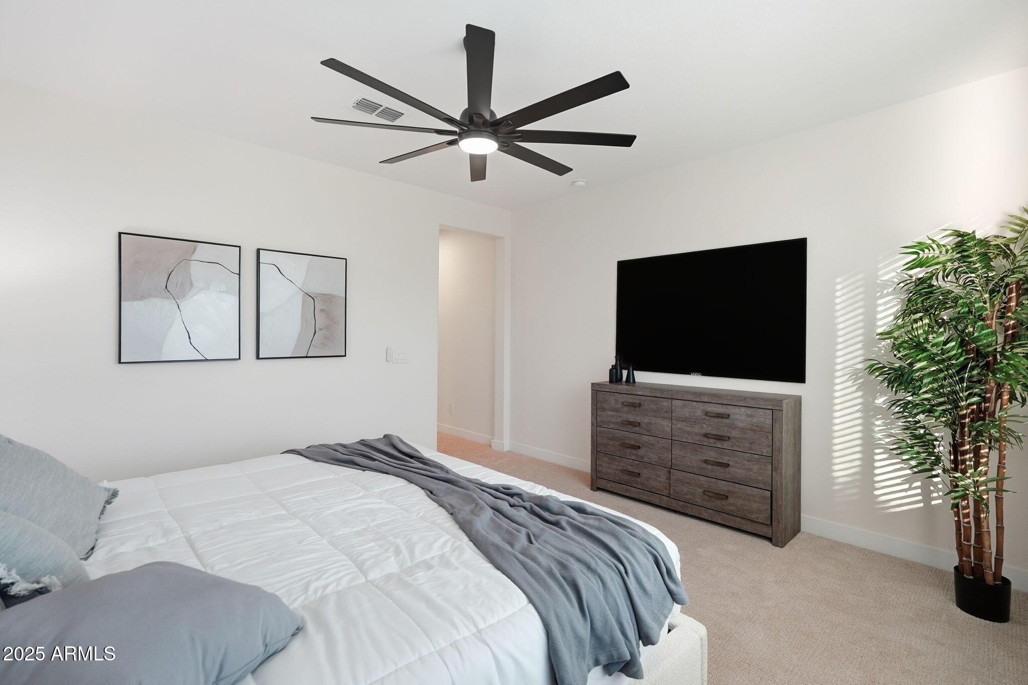 8159 West Cinder Brook Way Florence, AZ 85132 - Photo 24 of 32 a bedroom with a bed and a flat screen tv