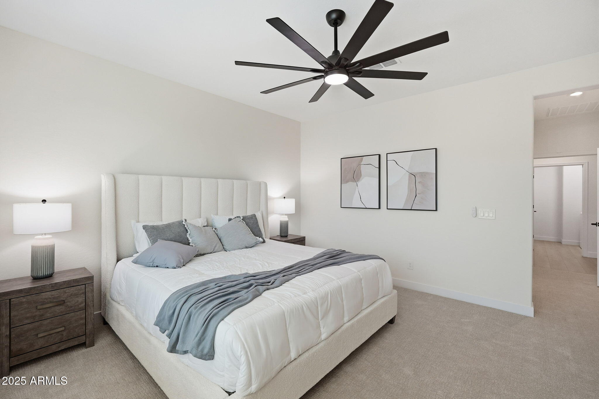 8159 West Cinder Brook Way Florence, AZ 85132 - Photo 25 of 32 a bedroom with a large bed and a chandelier