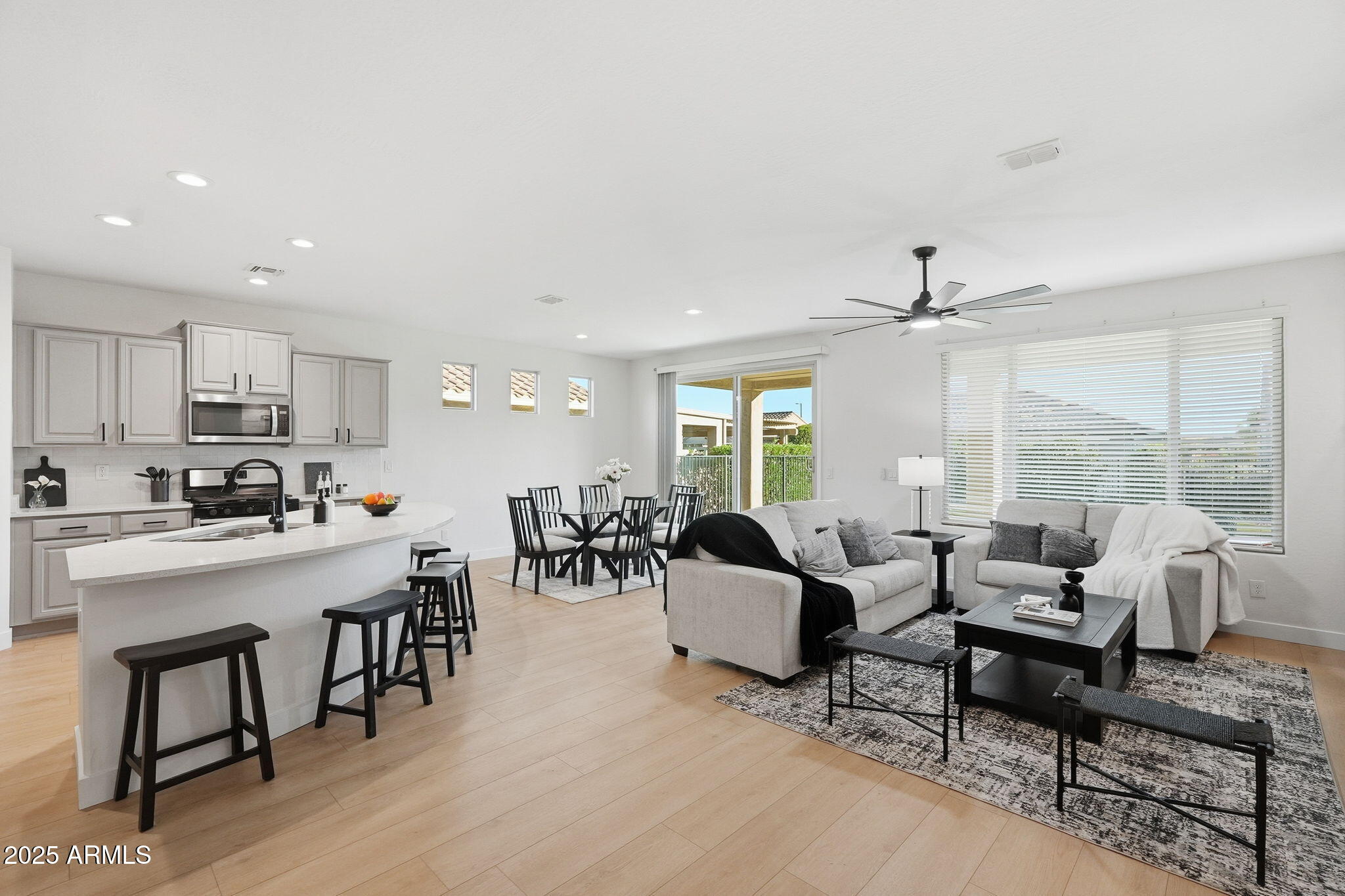 8159 West Cinder Brook Way Florence, AZ 85132 - Photo 3 of 32 a living room with furniture kitchen view and a large window