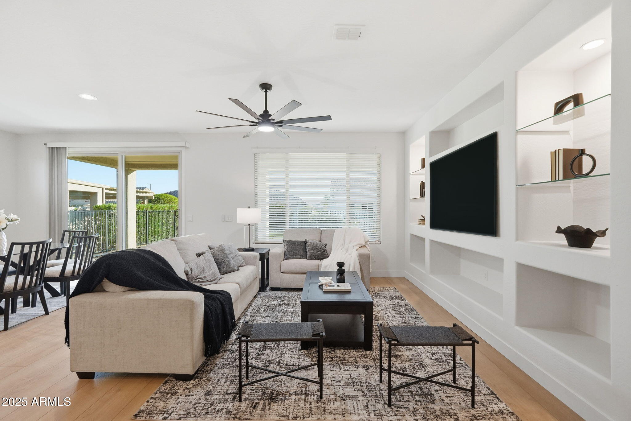 8159 West Cinder Brook Way Florence, AZ 85132 - Photo 5 of 32 a living room with furniture a large window and a flat screen tv