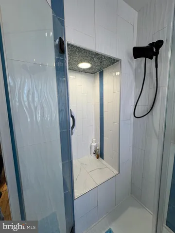 a bathroom with a shower and a sink