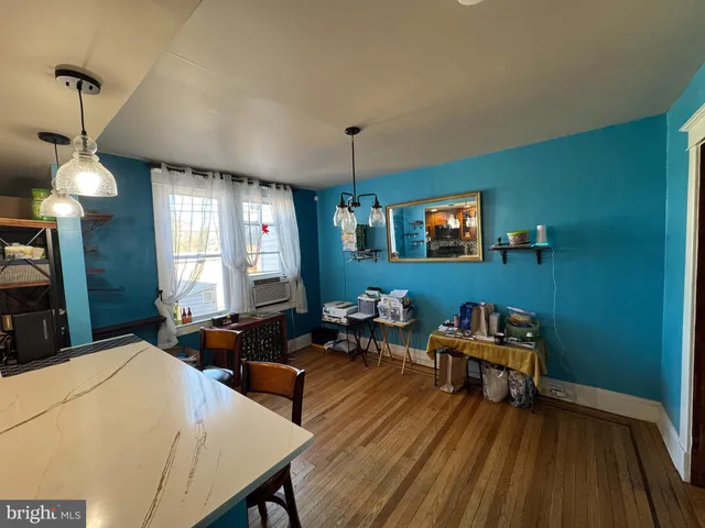 a living room with furniture a window and wooden floor
