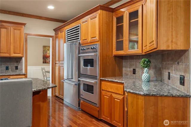 a kitchen with stainless steel appliances granite countertop a sink and cabinets