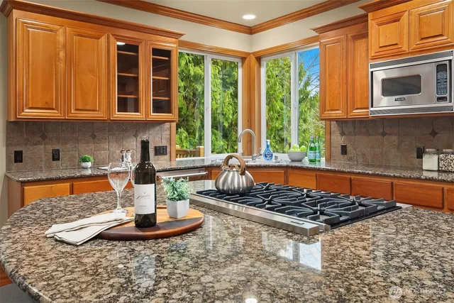 a kitchen with a stove a sink and a window