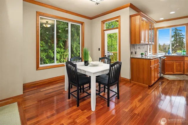 a view of a dining room with furniture window and wooden floor