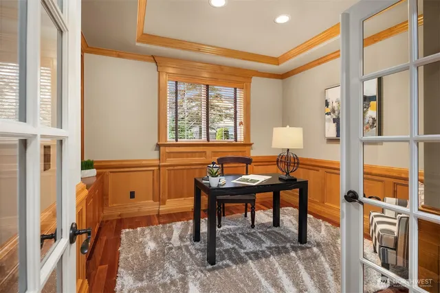 a view of a workspace with furniture and a window