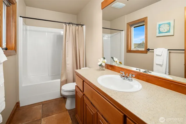 a view of a bedroom with furniture and window