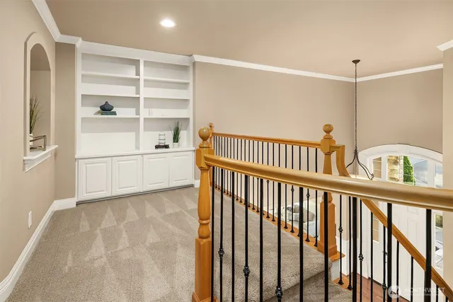 a spacious bedroom with a bed and glass window