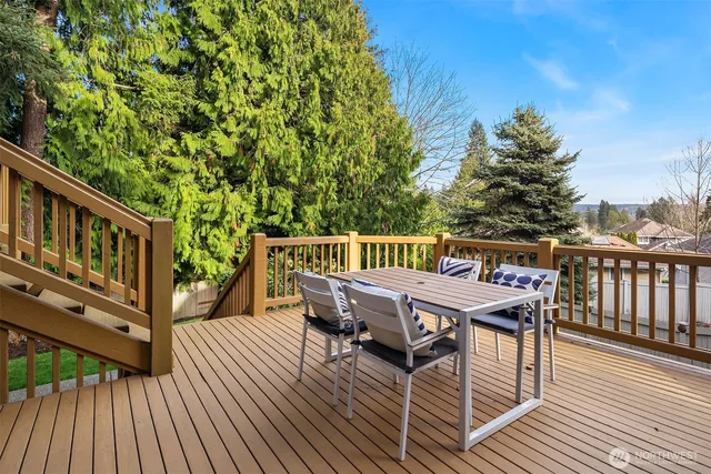 a view of a backyard with furniture and a fire pit