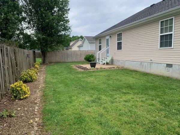a view of a house with backyard and sitting area