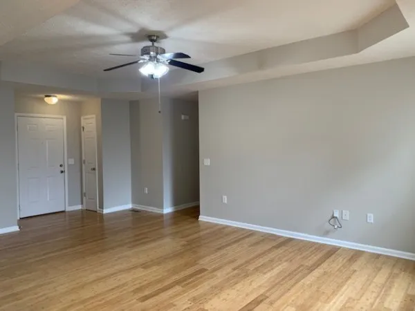 a view of an empty room and wooden floor