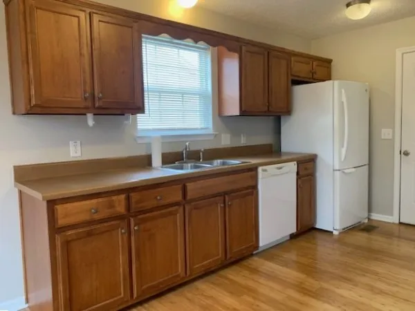 a kitchen with stainless steel appliances granite countertop a refrigerator sink and cabinets