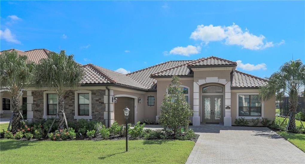 5528 Arnie Loop Lakewood Ranch, FL 34211 - Photo 1 of 59 a front view of a house with garden