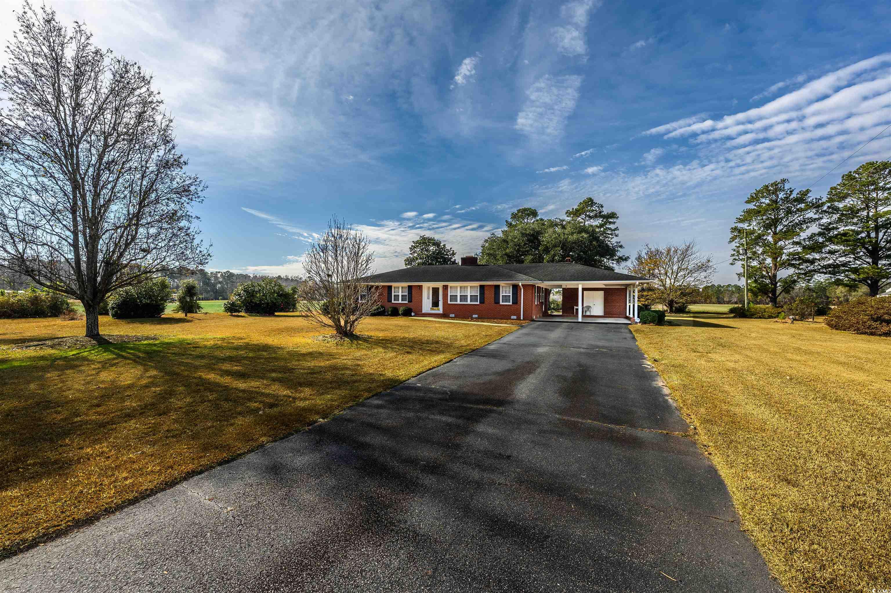 1870 Highway 348 Loris, SC 29569 - Photo 32 of 34 Single story home with driveway, a front yard, a chimney, and a carport