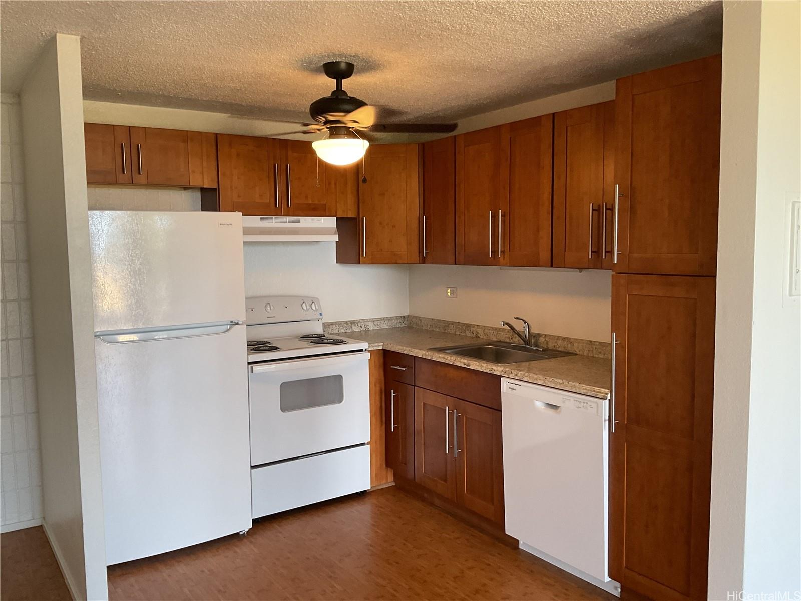 85-003 Pokai Bay Street, Unit 403 Waianae, HI 96792 - Photo 8 of 22 a kitchen with stainless steel appliances granite countertop a refrigerator a sink a stove and white cabinets