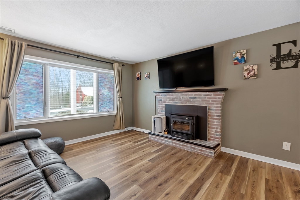 24 George Street Charlton, MA 01507 - Photo 16 of 42 a living room with furniture and a fireplace