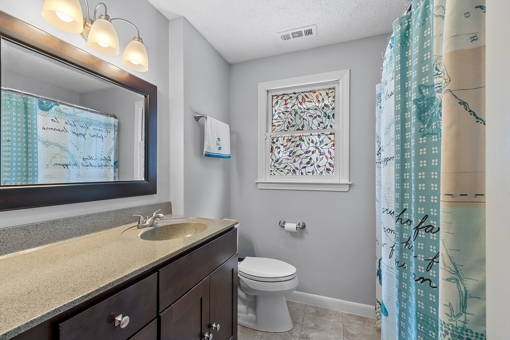 24 George Street Charlton, MA 01507 - Photo 18 of 42 a bathroom with a toilet a sink and a large mirror