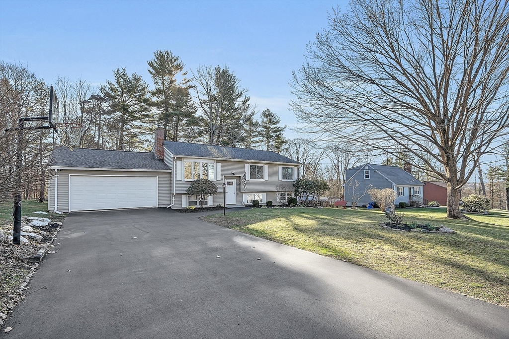24 George Street Charlton, MA 01507 - Photo 2 of 42 a view of a house with a large tree in front of it