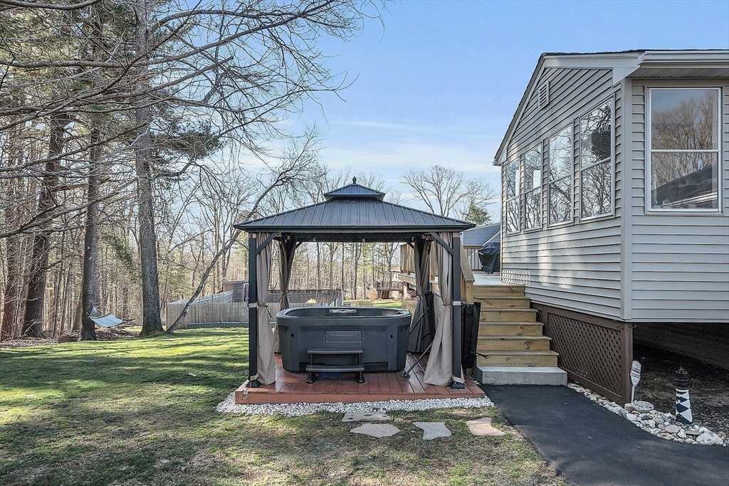 24 George Street Charlton, MA 01507 - Photo 38 of 42 a view of a backyard with a garden and deck