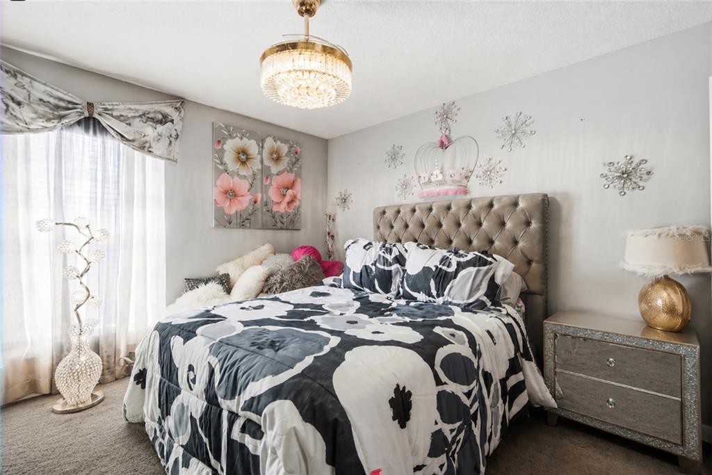 3005 West Chestnut Street Tampa, FL 33607 - Photo 19 of 27 a bed room with a bed and a chair