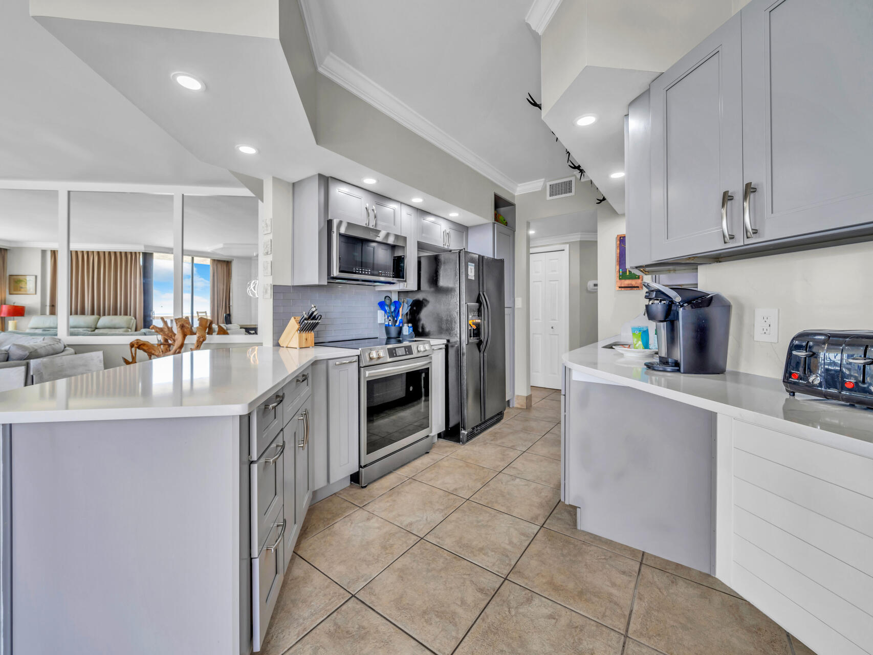 1096 Scenic Gulf Drive, Unit 1401/1401A Miramar Beach, FL 32550 - Photo 21 of 77 a kitchen with stainless steel appliances kitchen island granite countertop a sink and cabinets