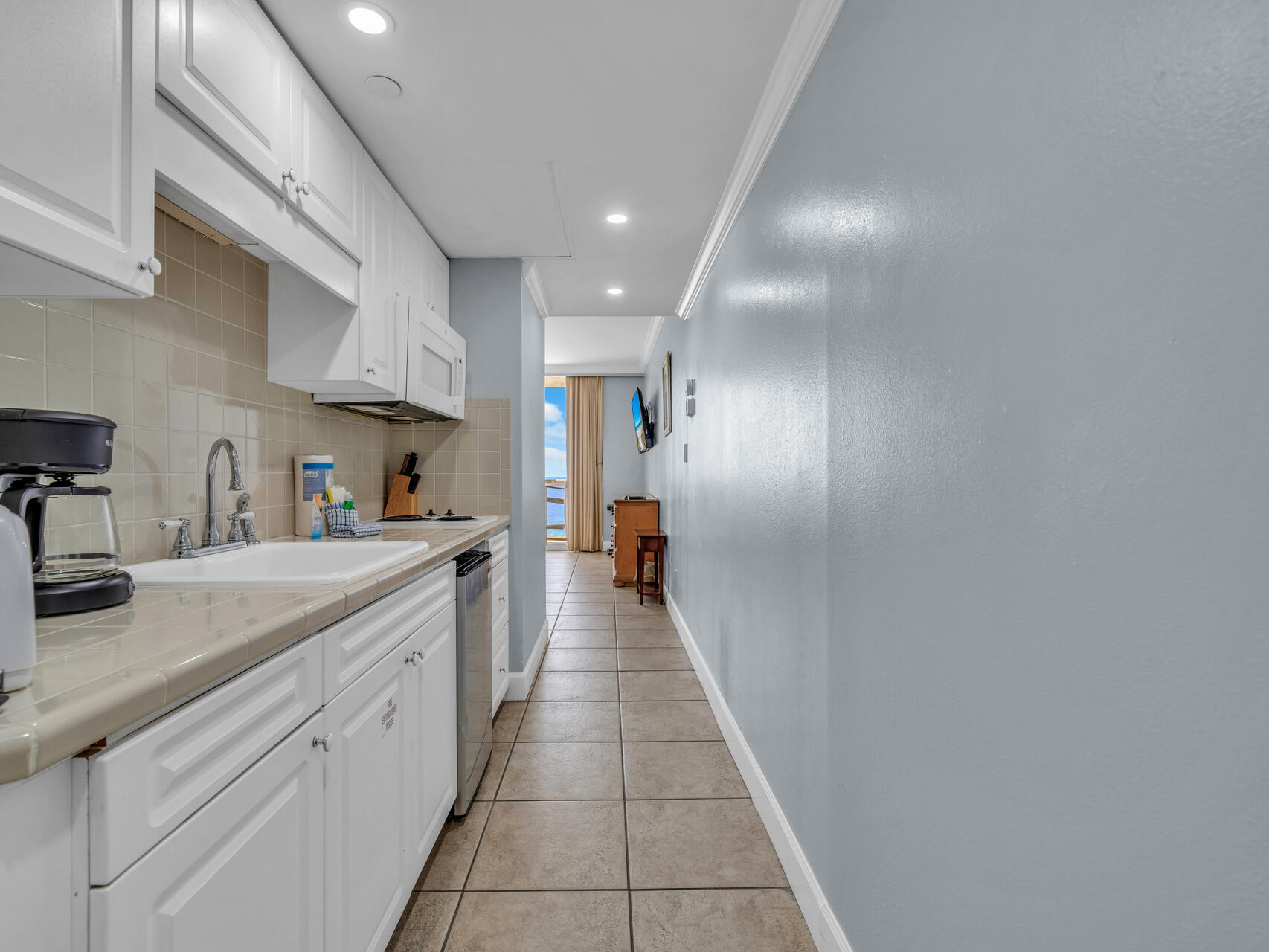1096 Scenic Gulf Drive, Unit 1401/1401A Miramar Beach, FL 32550 - Photo 30 of 77 a kitchen with stainless steel appliances granite countertop a sink and cabinets
