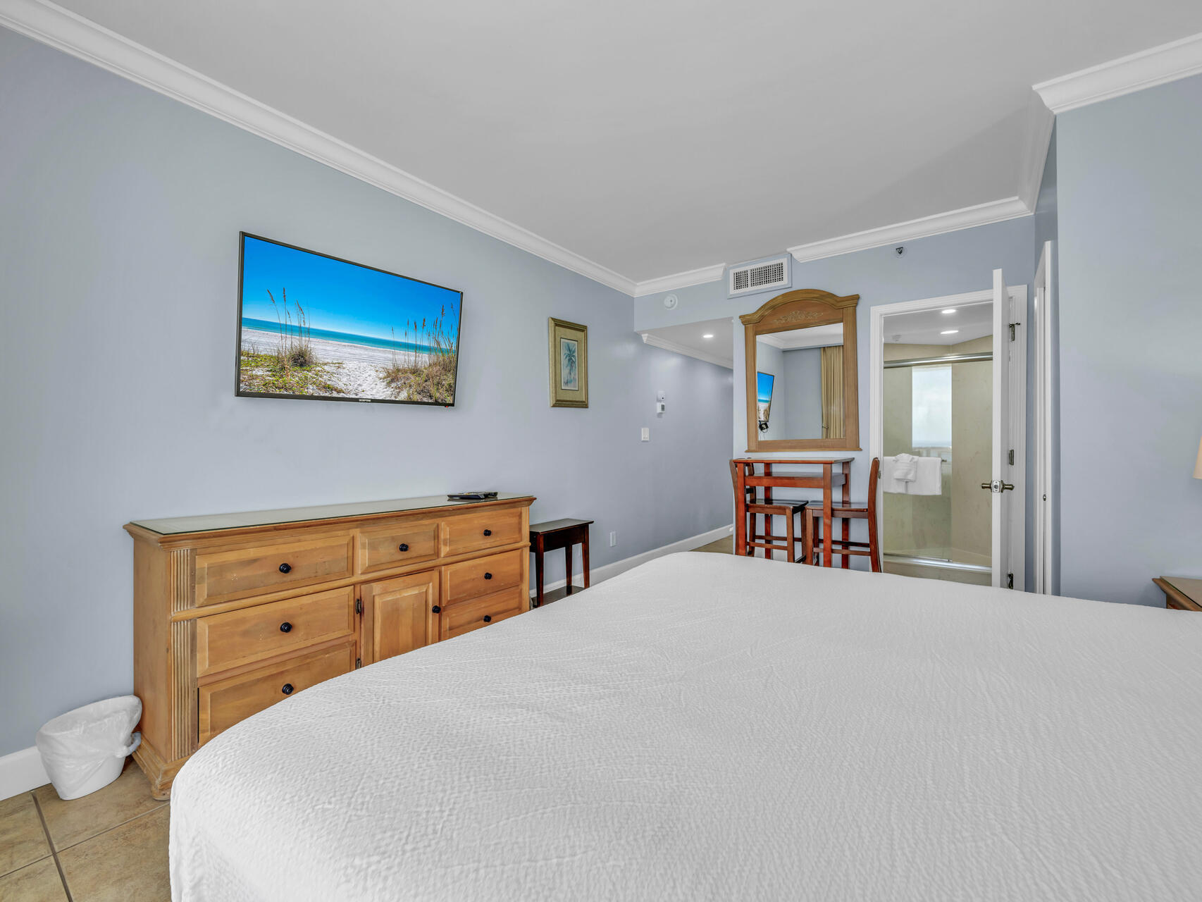 1096 Scenic Gulf Drive, Unit 1401/1401A Miramar Beach, FL 32550 - Photo 38 of 77 a bedroom with a bed and a chandelier