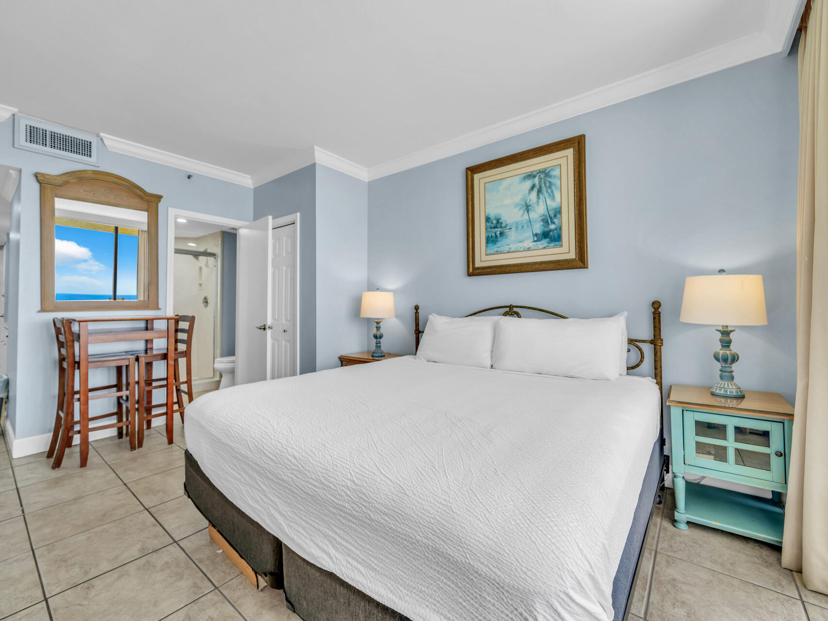 1096 Scenic Gulf Drive, Unit 1401/1401A Miramar Beach, FL 32550 - Photo 40 of 77 a bedroom with a bed and a lamp on table