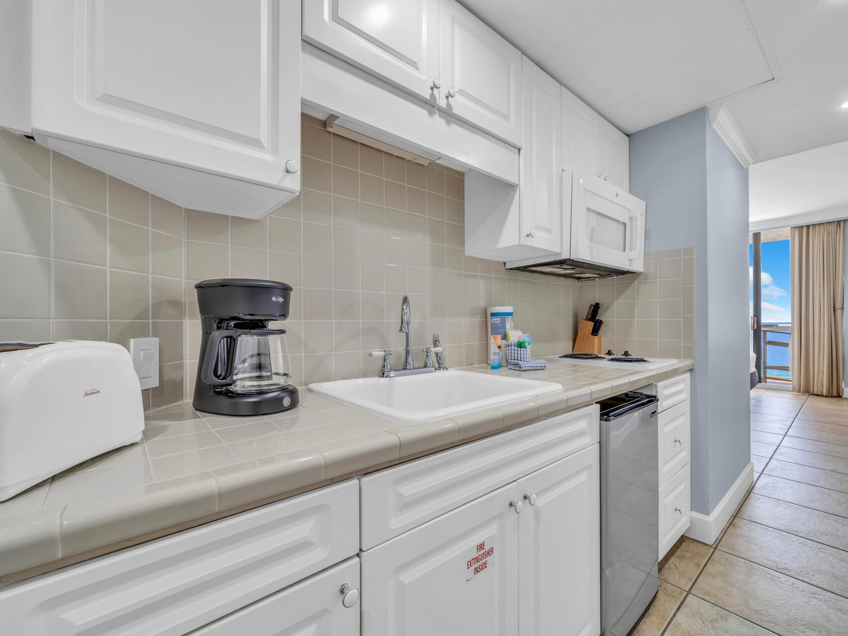 1096 Scenic Gulf Drive, Unit 1401/1401A Miramar Beach, FL 32550 - Photo 42 of 77 a kitchen with cabinets and window